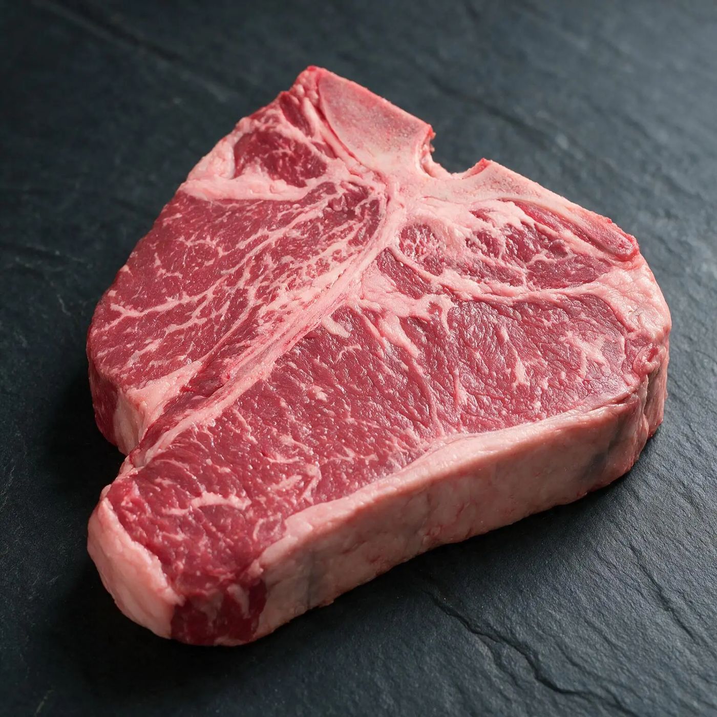 Black Angus Porterhouse halal UK supplier on dark slate